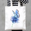 White canvas tote bag featuring blue butterfly and flower watercolor print - Blue Flower & Butterfly (STD707-W)