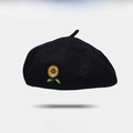 Classic black wool beret with detailed sunflower embroidery on a clean white background - One Size / Black