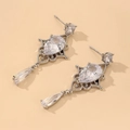 Macro shot of baroque style drop earrings with pear-cut cubic zirconia and silver lace detail - Silver Waterdrop Zirconia Drop Earrings (HE4909)