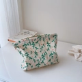 Detailed view of floral cotton toiletry bag with zipper and natural leaf pattern - Salt Shrink White Background Green Leaves