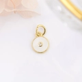 Macro detail of a round gold-plated eye pendant with enamel and zircon for jewelry DIY - White