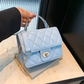 Quilted light blue crossbody bag with metal chain strap and turn-lock closure - Blue