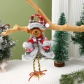 Detail of plush Christmas bear ornament with red plaid hat and bells on a wooden branch - Bear