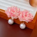Macro detail of pink fabric flower earrings with large white pearls on a wooden stand - 925 Silver Needle - Pink Flower Pearl Studs