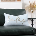 Detail of light blue velvet pillow with gold foil relax text on green leather sofa - Ice Blue Relax Gold Bronzing