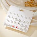 Set of 12 pairs of silver-tone stud earrings with pearls and hollow heart shapes on a card - Silver Rhinestone Pearl Star Moon Earrings (E1939-1)