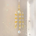 Detail of K9 crystal sun catcher showing rainbow reflections from clear prism balls - Yellow