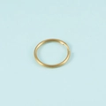 Detail of a golden stainless steel split key ring with a smooth polished metal finish - Gold