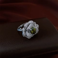 Macro shot of silver flower ring with green gem and rose petal zircon detailing - Green Main Stone / Silver-Green