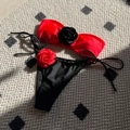 Two-piece colorblock bikini featuring a red bandeau top and black drawstring bottoms with roses - S / Red