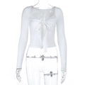 Detail of white long sleeve crop top with lace trim and delicate bow tie neckline - S / White