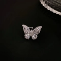 Macro shot of silver butterfly ear cuff with sparkling zircon crystals on black background - Silver - Right Ear Single