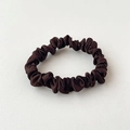 Macro detail of the smooth dark brown satin scrunchie on a white textured backdrop - Dark Coffee