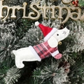 Close-up of a festive dachshund ornament wearing a Santa hat on a Christmas tree - Dachshund in Sweater / White