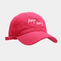 Close-up of white 'Keep Going' embroidery on a vibrant magenta cotton baseball cap - Rose Red
