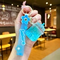Detail of blue liquid acrylic iceberg cup keychain with Sakura silicone wrist strap - Cherry Blossom Rope [blue] Glow-in-the-dark Dried Flower Iceberg Cup
