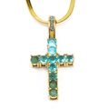 Macro shot of gold-tone cross pendant with blue and green crystals on snake chain - Gold Aqua Blue Gemstone