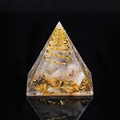 Orgone pyramid with rose quartz, gold foil and copper spiral on black background - Fluorite