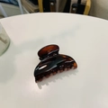 Detail view of deep brown tortoise shell hair claw clip with glossy plastic finish - Approx 6.8cm / Glossy Red Brown