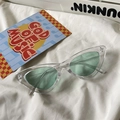 Close-up of retro cat-eye sunglasses with mint green lenses on white fabric - Cat Eye / Transparent Frame Green Lens