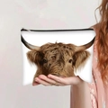 Detail of Highland Cow print makeup bag held by a person showing the realistic animal pattern - Majestic Highland Cow Face (jiayingpbb0105)