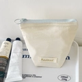 Creamy beige trapezoid makeup bag with light blue zipper and Purdored woven label - Lipstick Pouch / Cream