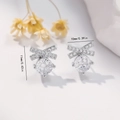 Macro detail of silver bow earrings with zircons showing dimensions 11mm by 10mm - EH757 Bowknot Zirconia Studs / Silver