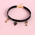 Detail of black velvet pet collar with gold cat and fishbone charms on pink background - XS (20-27cm) / Black Velvet Cat