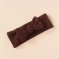 Detail shot of a brown knitted baby headband with a soft textured bow design - Brown