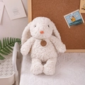 Plush beige lop-eared rabbit doll with fluffy curly fur and a decorative neck tag - White Rabbit / 35cm