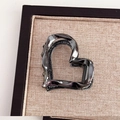 Detailed view of gunmetal heart-shaped metal hair claw clip on brown fabric base - Heart / Gunmetal