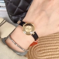 Minimalist gold round ladies watch with black leather strap on wrist with jewelry - Gold Case Black Strap