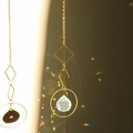 Golden geometric suncatcher with circular frame and faceted crystal ball reflecting rainbows - Design No.25