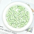 Macro view of light green fish-shaped ceramic beads for DIY jewelry making and crafts - Light Water Green