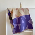 Close-up of geometric color block scarf with soft knit texture and fringe edge detail - Purple