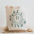 Cream canvas tote bag featuring green Spooky Vibes Halloween print and spider design - Spooky Vibes Dark Green Web