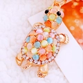 Turtle keychain with colorful cat eye stones and rhinestones on white faux fur - Colorful Fortune Turtle