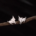 Polished stainless steel dog stud earrings in silver finish on natural wood - Running Puppy (781) / Steel