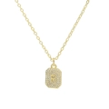 Macro shot of gold square pendant with cubic zirconia letter R on a clean white backdrop - Necklace R