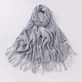 Elegant grey cashmere scarf with soft tassels shown flat on a white background - Light Gray