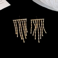 Detail of elegant gold tassel earrings featuring delicate metal beads on dark background - Gold (S925 Silver Pin)