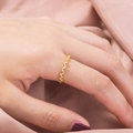 Close-up of elegant gold wave ring with micro-set zircons worn on model's hand - Color Retention Wave Pattern