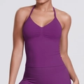 Detail of fuchsia halter yoga top featuring ribbed hem and central pleated texture - Plum Purple