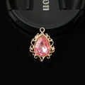 Detail of pink teardrop crystal pendant in a vintage gold hollow filigree setting - Light Pink
