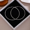 Detailed view of silver hoop earrings with polished mirror finish in a black gift box - 7cm Diameter/Silver