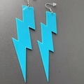 Close-up of vibrant blue acrylic lightning bolt earrings with secure silicone backs - Sky Blue