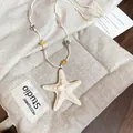 Collana con pendente a stella marina e perle color crema su sacchetto di lino - 42# Collana-Bianco