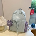 Light blue and lavender color-block backpack with a purple heart-shaped lucky charm pouch - Blue