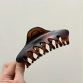 Macro detail of dark tortoiseshell hair claw clip with strong sawtooth grip for thick hair - Matte Red Brown