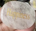 Polished transparent oval crystal stone featuring golden engraved Happiness text - White Crystal